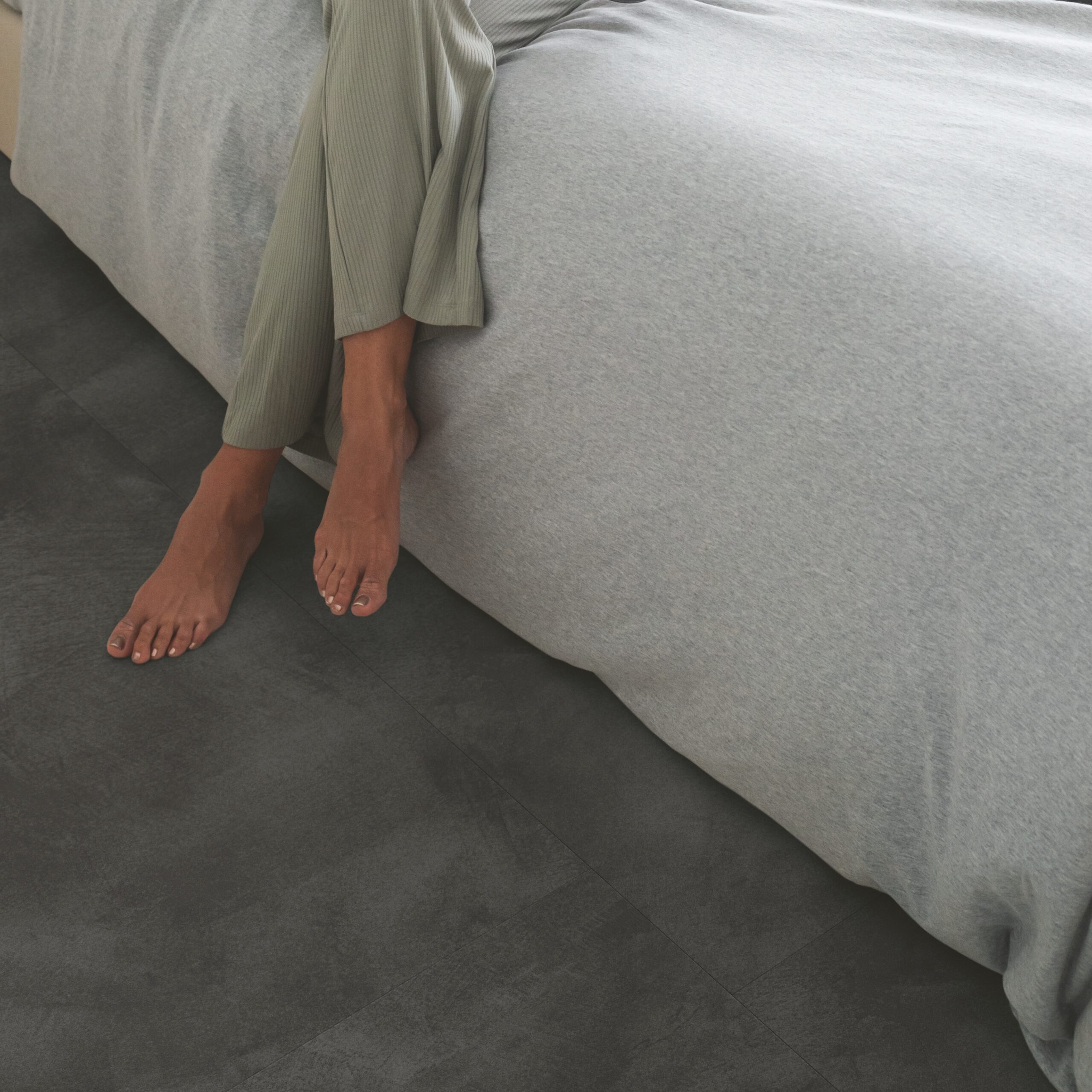 dark flooring next to bed